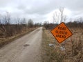 Orange road closed ahead sign with trail or path Royalty Free Stock Photo