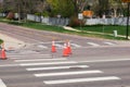 Orange road construction safety traffic cones during road repair construction maintenance work at crossroads Royalty Free Stock Photo