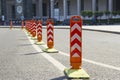 Orange road dividers. Curved line of dividing posts on the double road marking line