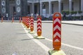 Orange road dividers. Curved line of dividing posts on the double road marking line