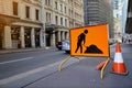 Road work ahead symbol sign applying on busy business center