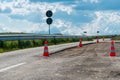 Orange road work cones, indicators on damaged  asphalt road Royalty Free Stock Photo