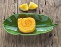 Orange roll cake on banana leaf plate