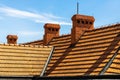 Orange roof and chimneys against the background of blue sky Royalty Free Stock Photo