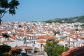 Orange roof tops and whitwashed walls of Skiathos town from top of hill with church of Saint Nikolaos