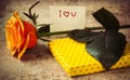 Orange rose, gift covered in hearted paper and note I love you Royalty Free Stock Photo