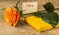 Orange rose, gift covered in hearted paper and note I love you Royalty Free Stock Photo