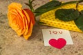 Orange rose, gift covered in hearted paper and note I love you Royalty Free Stock Photo