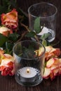 Orange roses with lightning candle Royalty Free Stock Photo