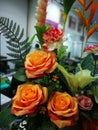 Orange roses and variety flowers in vase Royalty Free Stock Photo