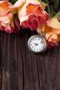 Orange roses with vintage clock Royalty Free Stock Photo