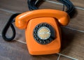 Orange retro telephone on wooden background Royalty Free Stock Photo