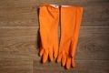 Orange rubber gloves lie on the table close up Royalty Free Stock Photo