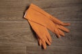 Orange rubber gloves lie on the table close up Royalty Free Stock Photo