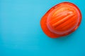 Orange safety helmet on blue background - Construction industry