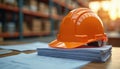 Orange safety helmet on pile of construction documents, blueprints. Protective hard hat for building site worker. Workplace Royalty Free Stock Photo