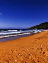 Orange sand beach and big waves Royalty Free Stock Photo