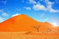Orange sand dune and bright blue cloudy sky Royalty Free Stock Photo
