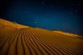 Orange sand dunes at night