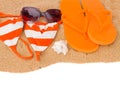 Orange sandals and swimming siut on sand Royalty Free Stock Photo