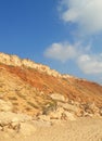 An orange sandy cliff by the beach