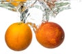 Orange sanguinello falling in water and splash on white background Royalty Free Stock Photo