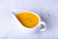 Orange sauce for duck poultry in a white gravy boat. Royalty Free Stock Photo