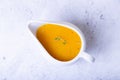 Orange sauce for duck poultry in a white gravy boat. Royalty Free Stock Photo