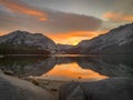 Orange scene refection on the water. Beautiful Rocks foreground Sunset Light aand dramatic sky at Lake in Yosemite National Park, Royalty Free Stock Photo