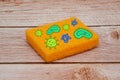 Orange scouring sponge with wood background Royalty Free Stock Photo