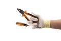 Orange screwdriver and pliers in the hand in glove isolated on white background Royalty Free Stock Photo