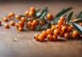 Orange sea buckthorn berries on a wooden table with copy space for text. Royalty Free Stock Photo