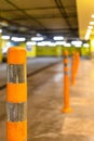 orange security bollard in underground parking