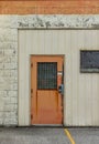 Orange security door with numbered keyless padlock entry