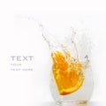 Orange segment falls in a glass
