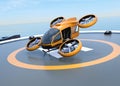 Orange self-driving passenger drone takeoff from helipad
