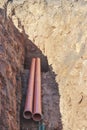 Orange sewer pipes in a trench. Laying communications in the ground during the construction of the building