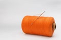Orange sewing thread with needle on white background Royalty Free Stock Photo