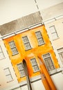 Orange shared twin elevation facade fragment with brick wall texture tiling shot with brush and pencils