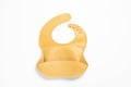 Orange silicone baby bib isolated on white, top view Royalty Free Stock Photo