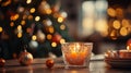 Orange and silver Candle holder with some Christmas balls put on a wood table with a blurry luminous Christmas tree