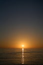 Orange sky with setting sun over the sea Royalty Free Stock Photo