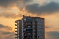 Orange sky at sunset, a high-rise building and the sun behind them, Clouds Royalty Free Stock Photo