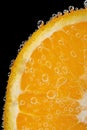 Orange slice with gas bubbles in water