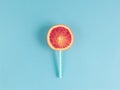 Orange slice with tubule, healthy candy on a stick, lollipop