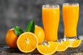 Orange sliced and orange juice glasses with green leaf on wooden table Royalty Free Stock Photo