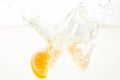 Orange Slices falling deeply under water with a big splash Royalty Free Stock Photo