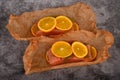 Salmon fillet with orange on baking paper