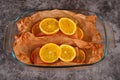 Salmon fillet with orange on baking paper