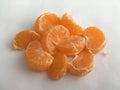 Orange slices of ripe mandarin lying on a white background. Macro shot.